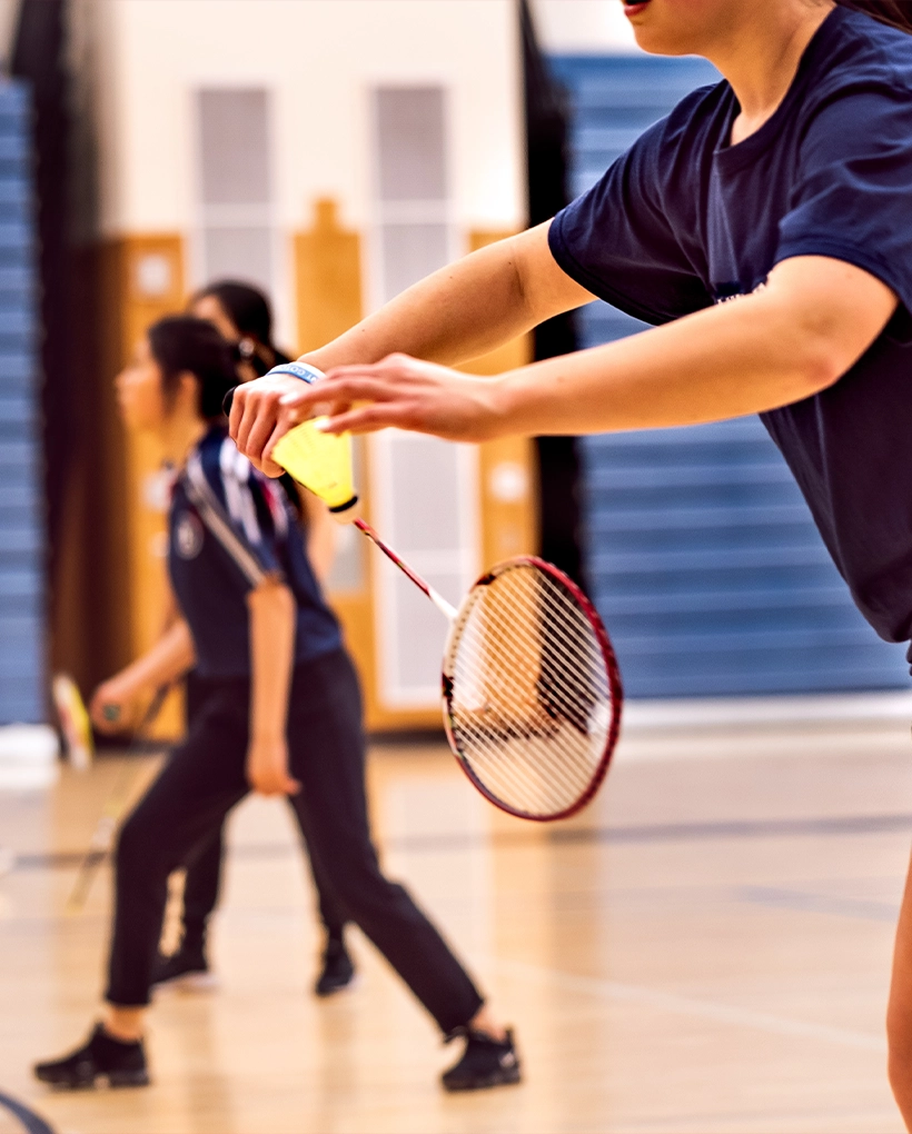 Badminton enthusiasts of all skill levels enjoy an exciting match at Rally Sports Club's indoor court during the Daily Badminton Drop-Ins.